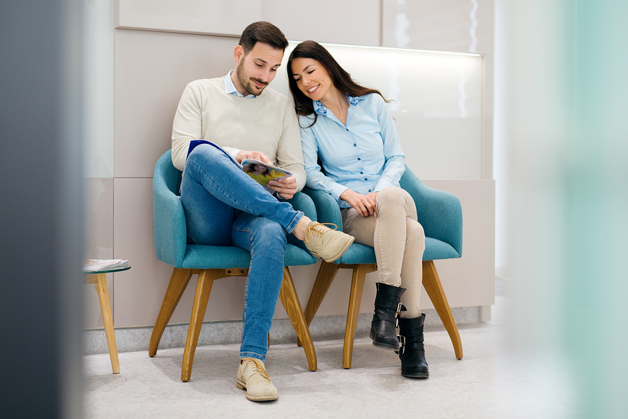 A couple waiting in a well designed dental office waiting room.