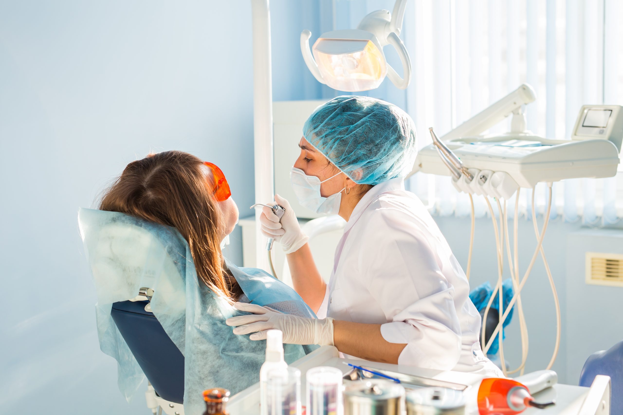 Masked dentist with patient