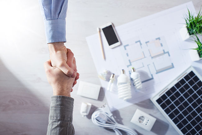 shaking hands during onbording of dental office design team member