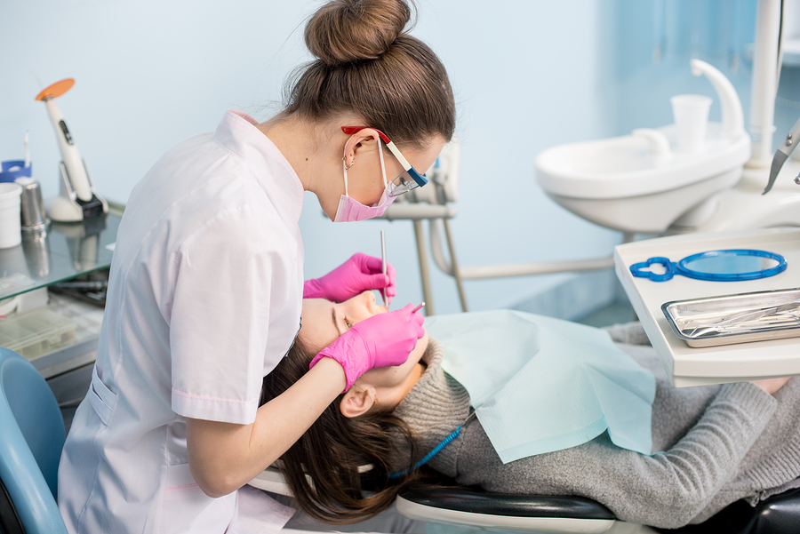 How Dental Office Design Ergonomics Can Save Your Practice, Ergonomically Designed dental operatory allows this practitioner easy access to her patient