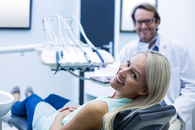 comfortable patient in dental office exam chair