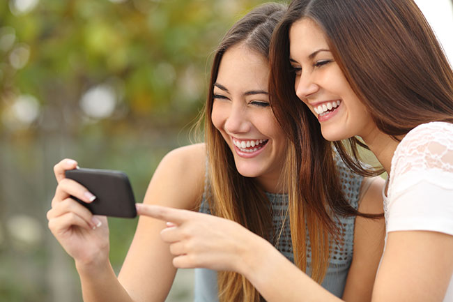 women taking cell phone video