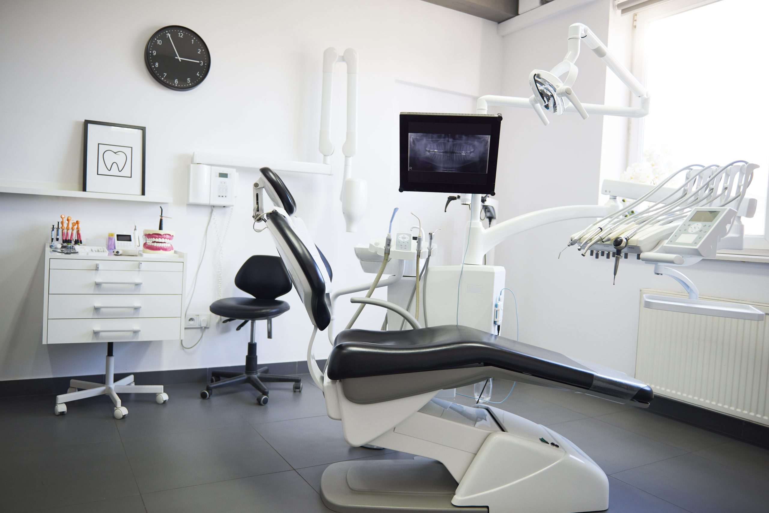 Empty dental treatment room with modern design elements and new dental equipment. 